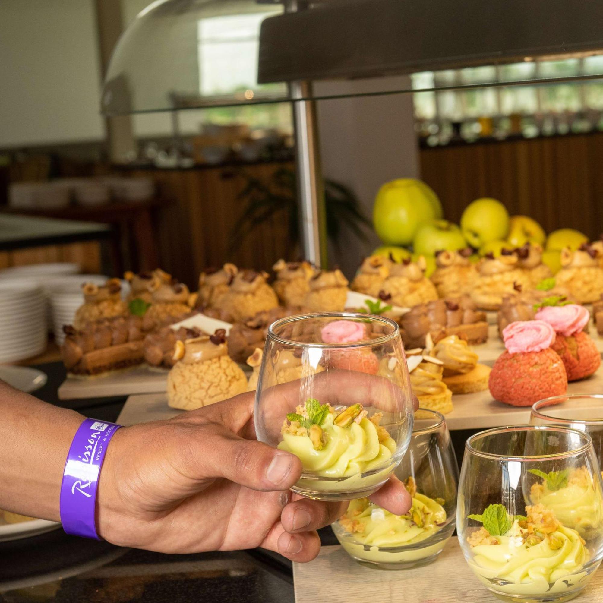 Radisson Blu Resort Al Hoceima Exterior photo A hand holding a glass of dessert